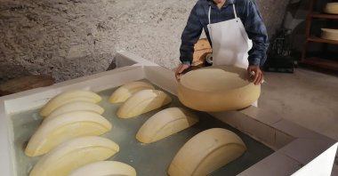 One of the sculptures in the Kars Cheese Museum depicts a man making cheese, Kars, Türkiye, Aug. 19, 2024. (IHA Photo)