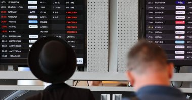 Passengers look at the flight board at Ben Gurion airport as some flights got canceled amid regional tensions, Tel Aviv, Israel, Aug. 6, 2024. (AFP Photo)