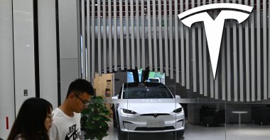 People walk past a Tesla shop at a shopping mall in Beijing, China, July 9, 2024. (AFP Photo)