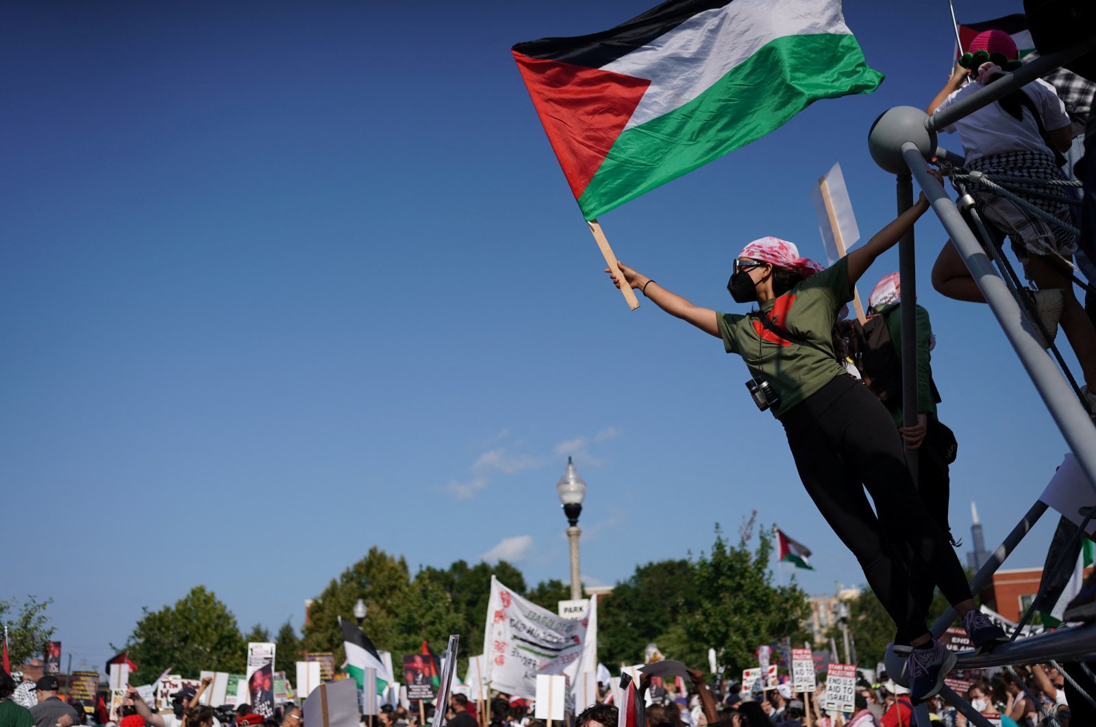 A demonstrator displays a Palestinian flag during the &quot;March on the DNC&quot; rally in Chicago, Illinois, U.S., Aug. 19, 2024. (Reuters Photo)