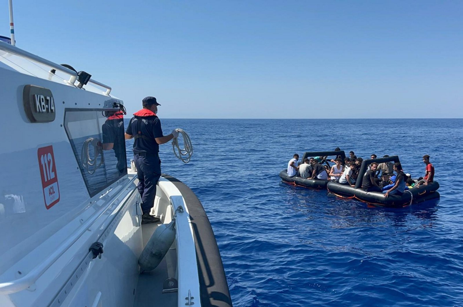 A Turkish Coast Guard Command boat approaches irregular migrants off the coast of Muğla, southwestern Türkiye, Aug. 19, 2024. (AA Photo)