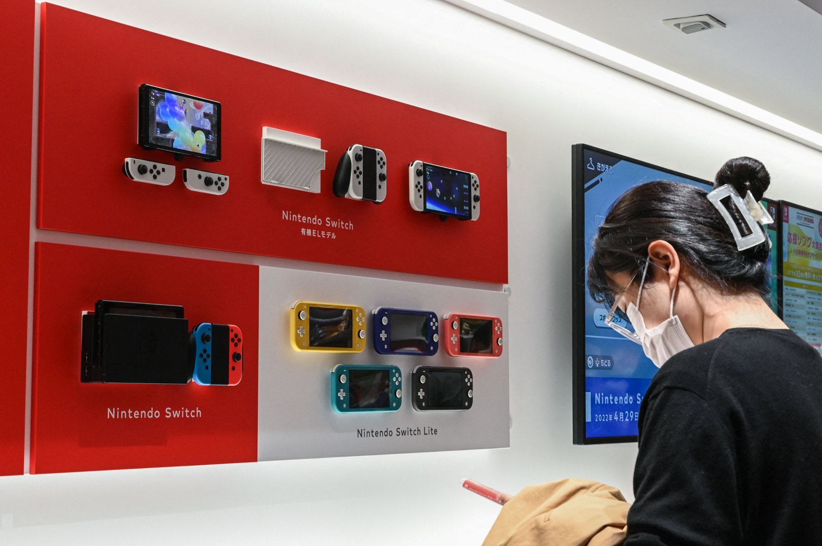 A woman looks at a Nintendo Switch display at a Nintendo store in central Tokyo, Japan, Nov. 6, 2023. (AFP File Photo)