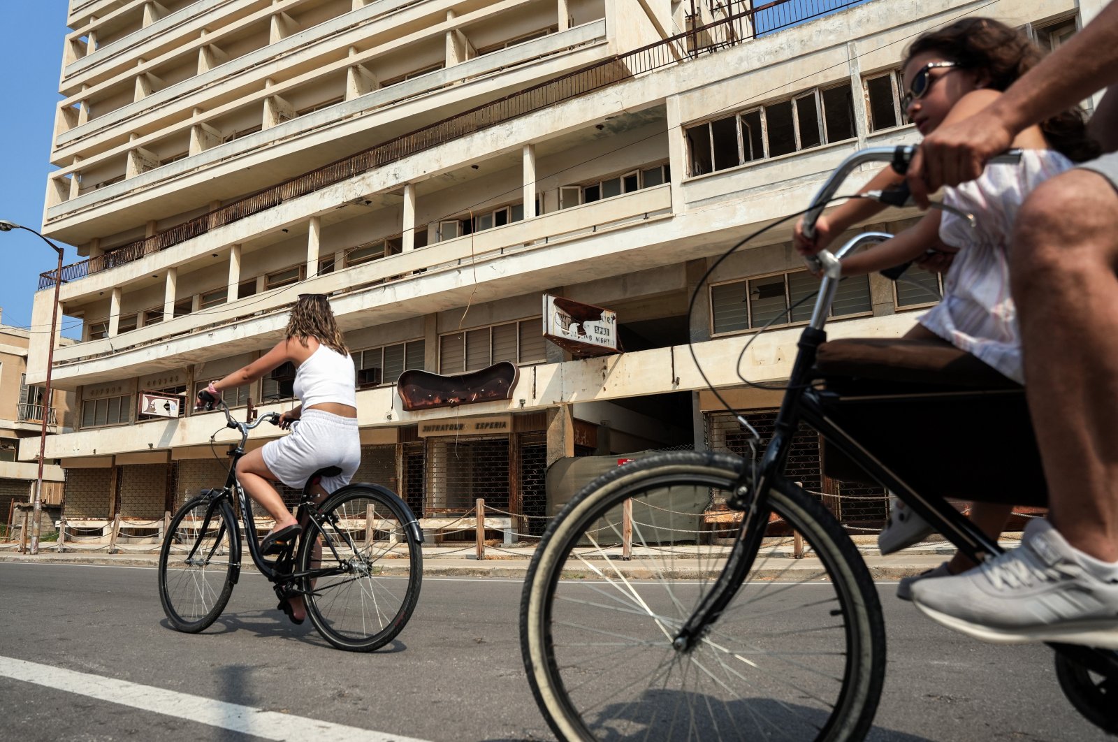 Tourists ride bicycles around the streets of Varosha, Turkish Republic of Northern Cyprus, July 29, 2024. (IHA Photo)