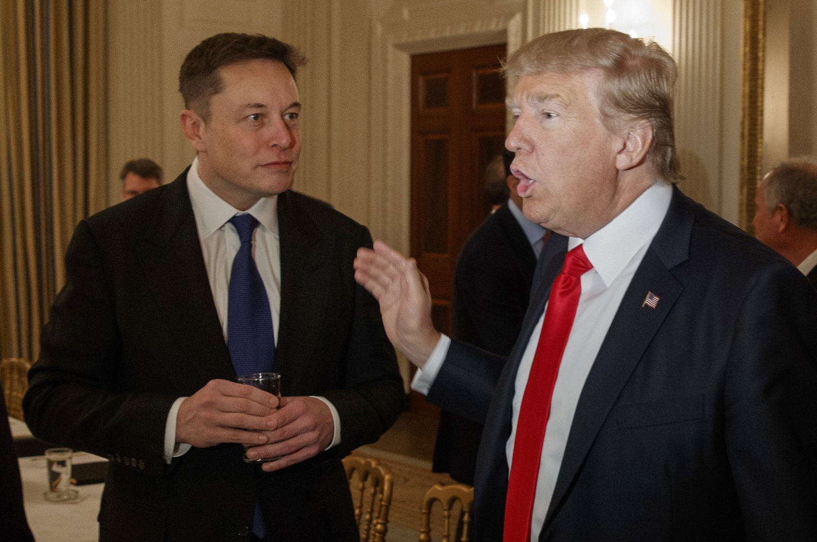 Then-President Donald Trump (R) talks with Tesla and SpaceX CEO Elon Musk at the White House in Washington, D.C, U.S., Feb. 3, 2017. (AP Photo)