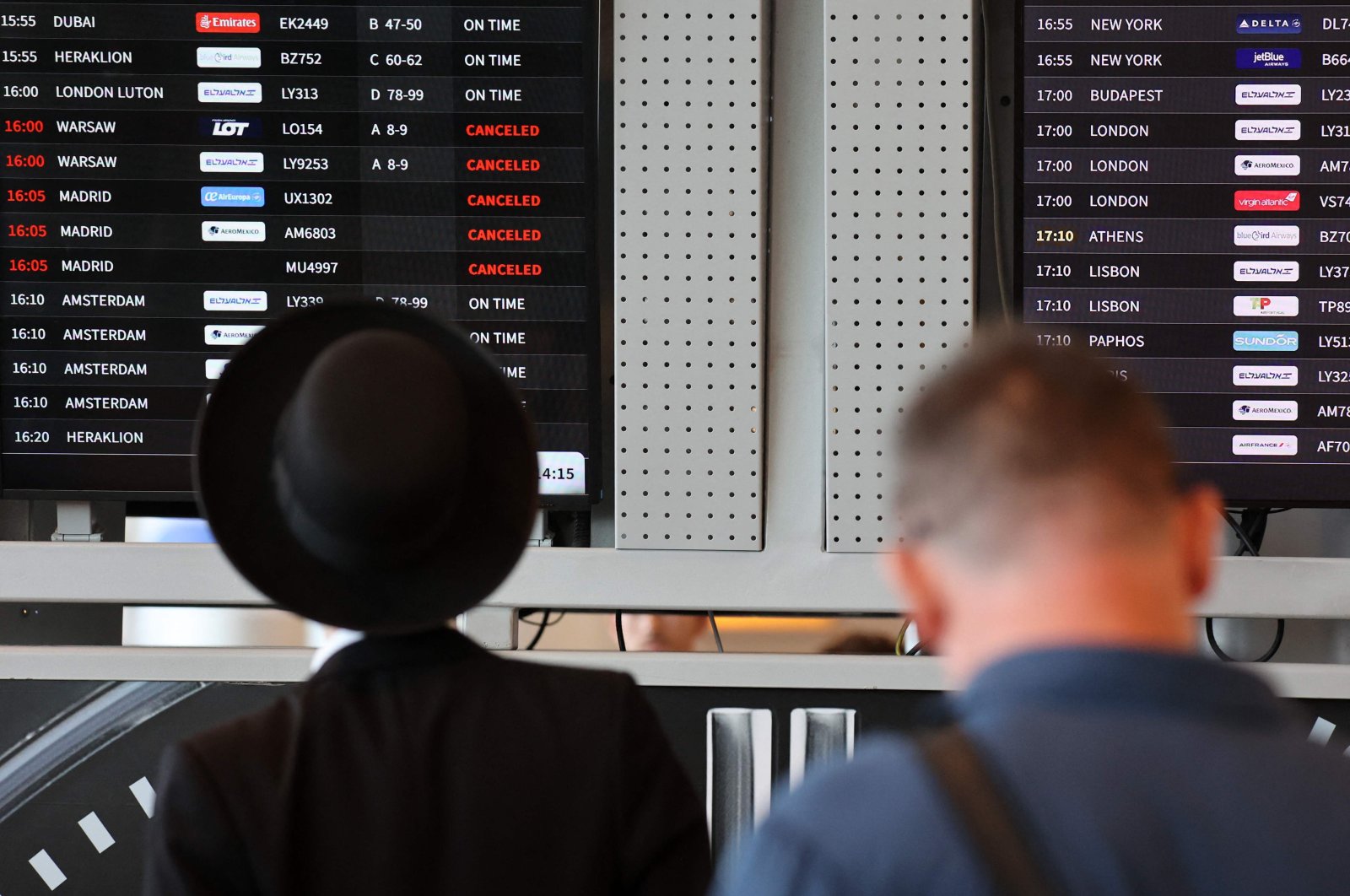 Passengers look at the flight board at Ben Gurion airport as some flights got canceled amid regional tensions, Tel Aviv, Israel, Aug. 6, 2024. (AFP Photo)