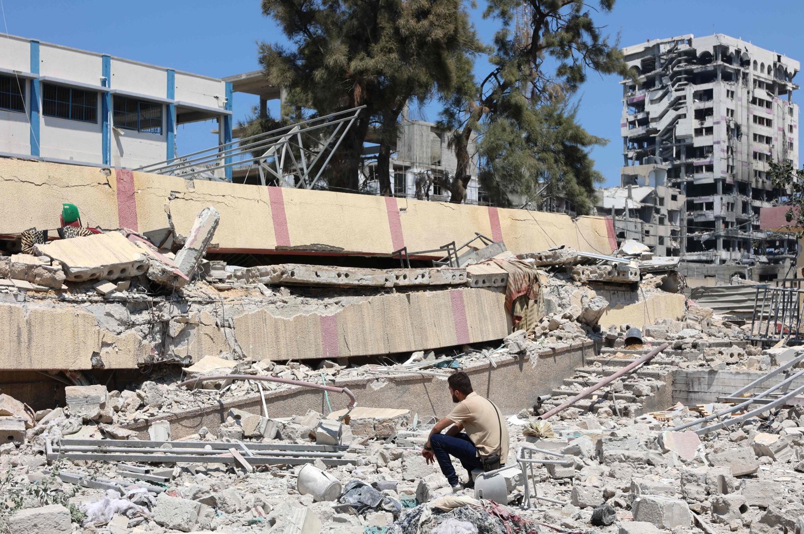 A man looks at the debris after an Israeli strike on a school housing displaced Palestinians, Rimal, central Gaza, Palestine, Aug. 20, 2024. (AFP Photo)