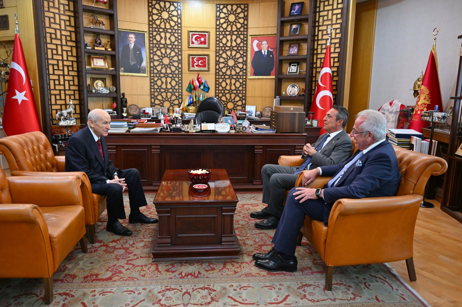 MHP leader Devlet Bahçeli (L) meets Fenerbahçe Chairperson Ali Koç (2nd R) and Fenerbahçe board member Erol Bilecik, in the capital Ankara, Türkiye, Aug. 19, 2024. (AA Photo)