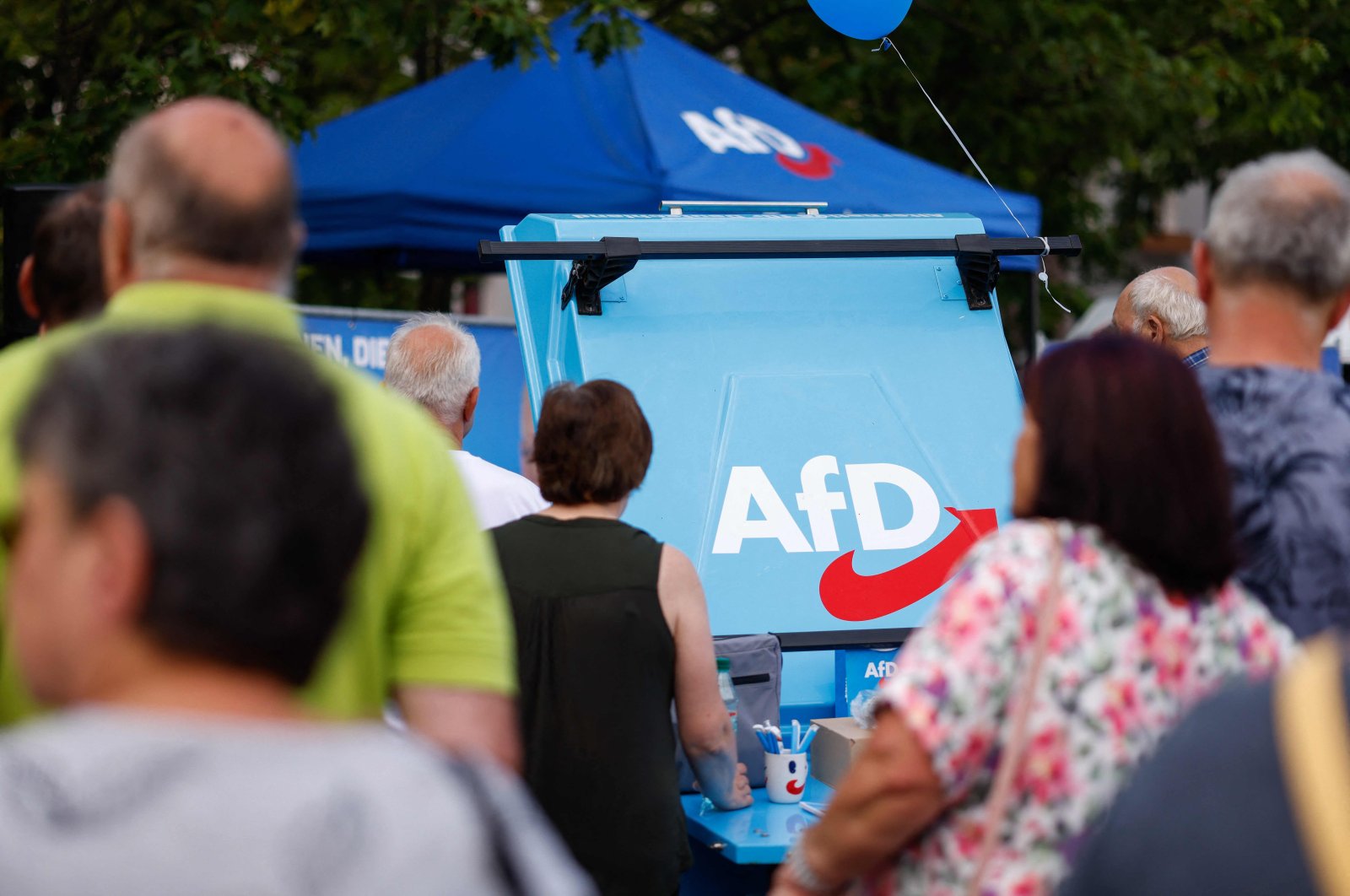 The logo of the far-right Alternative for Germany (AfD) party is seen on a grill as supporters gather for an AfD election campaign meeting in Weisswasser, Saxony, eastern Germany, Aug.14, 2024. (AFP Photo)