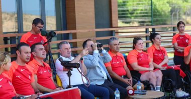 Türkiye’s Youth and Sports Minister, Osman Aşkın Bak (4th L) observes a training session for the national para-archers, Istanbul, Türkiye, Aug. 21,2 024. (DHA Photo)