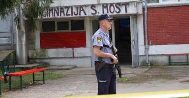 A police officer stands guard outside the scene of the shooting, Sanski Most, Bosnia-Herzegovina, Aug. 21, 2024. (Reuters Photo)