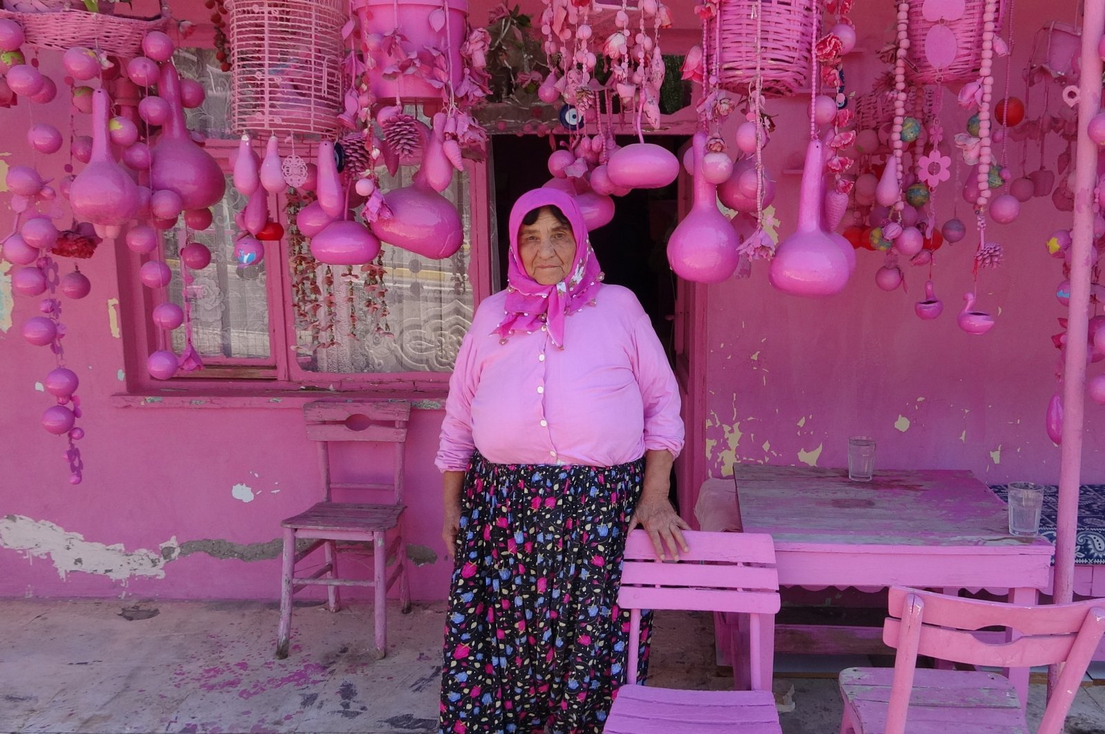 Sakine Akkul, 75, waiting in front of her pink house in Sav, Isparta, Türkiye, Aug. 21, 2024. (IHA Photo)