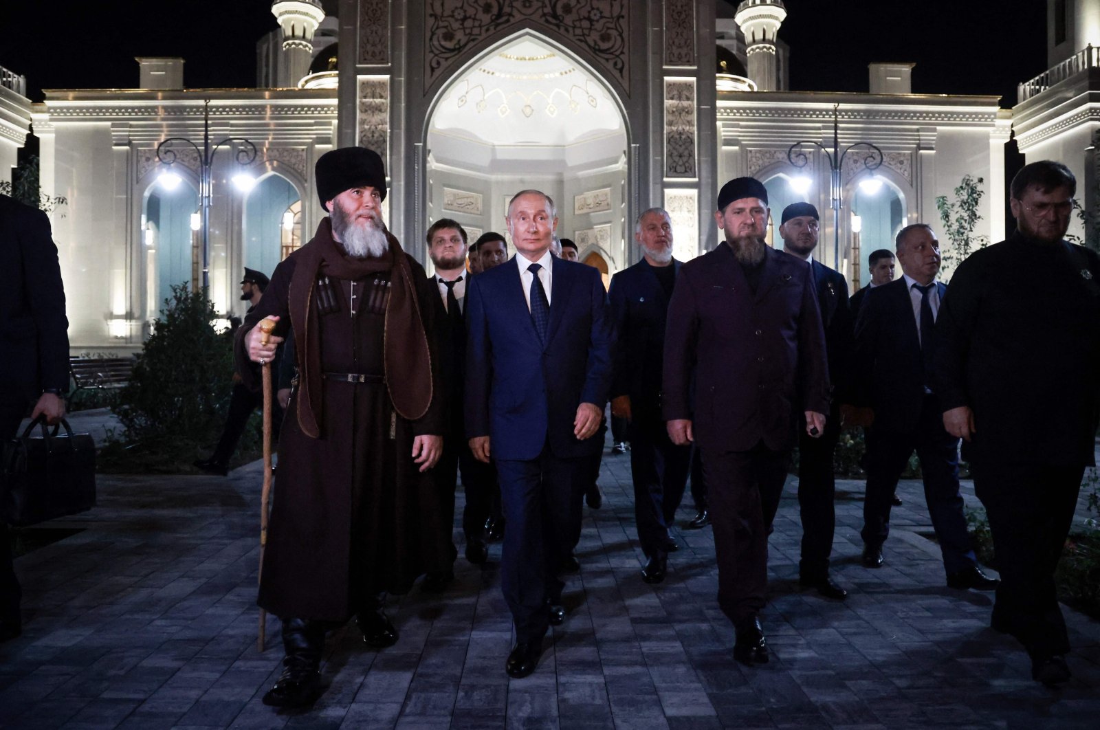 Russia&#039;s President Vladimir Putin (C) walks next to the head of the Chechen Republic Ramzan Kadyrov (C-R) and Mufti of Chechnya Sheikh Salah-Hadzhi Mezhiev (L) during his visit to Chechnya in Grozny on Aug. 20, 2024. (Sputnik, Handout via AFP)