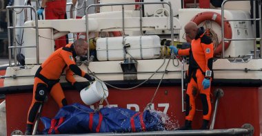 Rescue personnel pour water on a bodybag at the scene where a luxury yacht sank, off the coast of Porticello, near the Sicilian city of Palermo, Italy, Aug. 22, 2024. (Reuters Photo)
