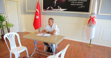 Mayor Menderes Dal traded his rotating leather seat with a plastic chair after the sequestration, Antalya, southern Türkiye, Aug. 21, 2024. (IHA Photo)