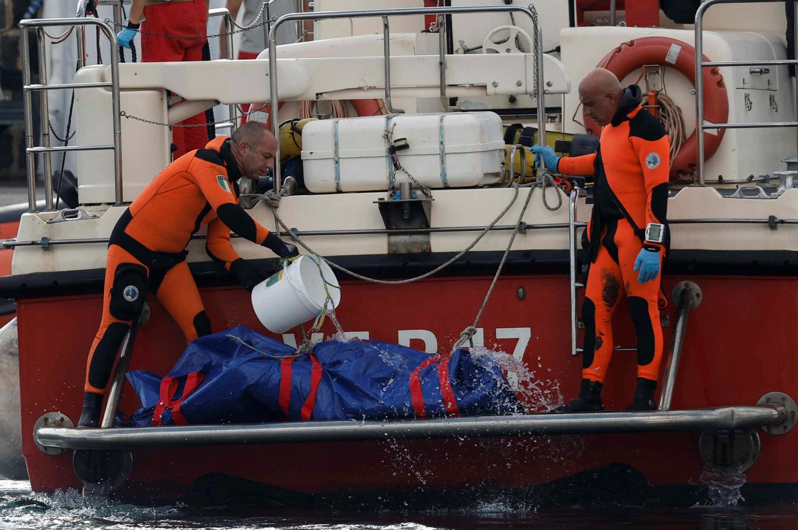 Rescue personnel pour water on a bodybag at the scene where a luxury yacht sank, off the coast of Porticello, near the Sicilian city of Palermo, Italy, Aug. 22, 2024. (Reuters Photo)