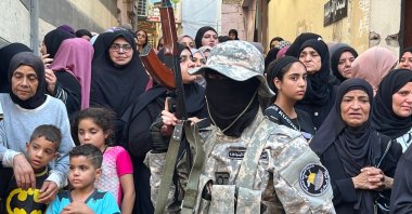 A Palestinian fighter stands guard as people attend the funeral of Khalil Maqdah, a senior militant from Fatah's armed wing, killed in an Israeli strike, in the Ain al-Helweh Palestinian refugee camp, near Sidon, southern Lebanon, Aug. 21, 2024. (AFP Photo)