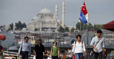 Pedestrians walk in Istanbul, Türkiye, July 19, 2018. (AP Photo)