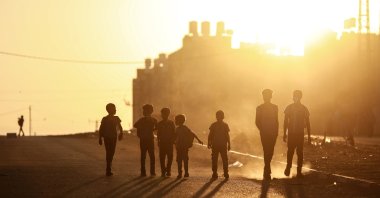 Palestinian students walk during sunrise as they make their way to school in the northern Gaza Strip, Palestine, Sept.19, 2021. (Reuters Photo)