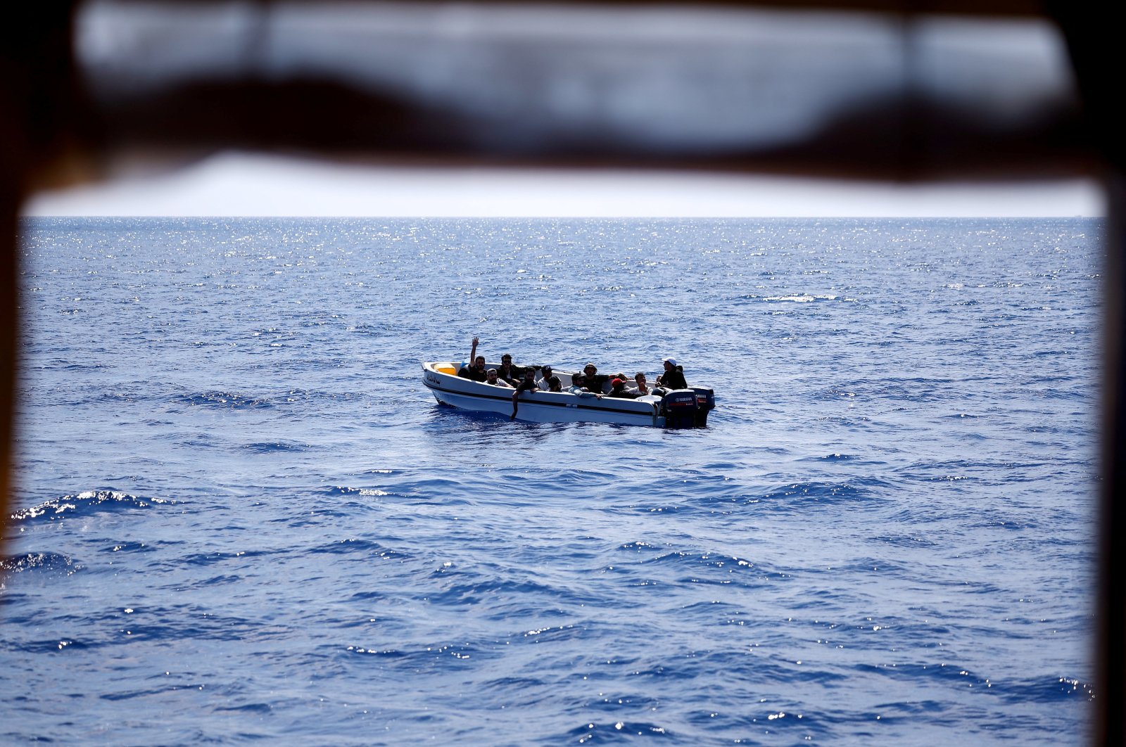 A migrant gestures to Open Arms NGO rescue boat &quot;Astral&quot; (not pictured) from a fibreglass boat in international waters south of Lampedusa, in the central Mediterranean Sea, Aug. 9, 2024. (Reuters Photo)