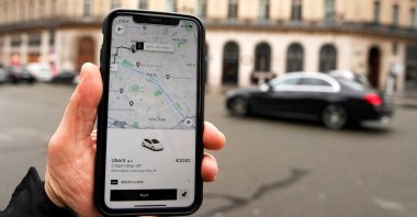 A photo Illustration shows the Uber application on a mobile phone in central Paris, France, March 5, 2020. (Reuters Photo)