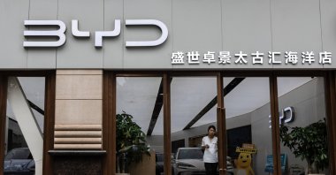 A woman exits a store of the electric vehicle manufacturer BYD, Shanghai, China, Aug. 21, 2024. (EPA Photo)