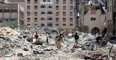 Palestinians inspect damage in Qatari-funded Hamad City, following an Israeli raid, in Khan Younis, in the southern Gaza Strip, Aug. 24, 2024. (Reuters Photo)