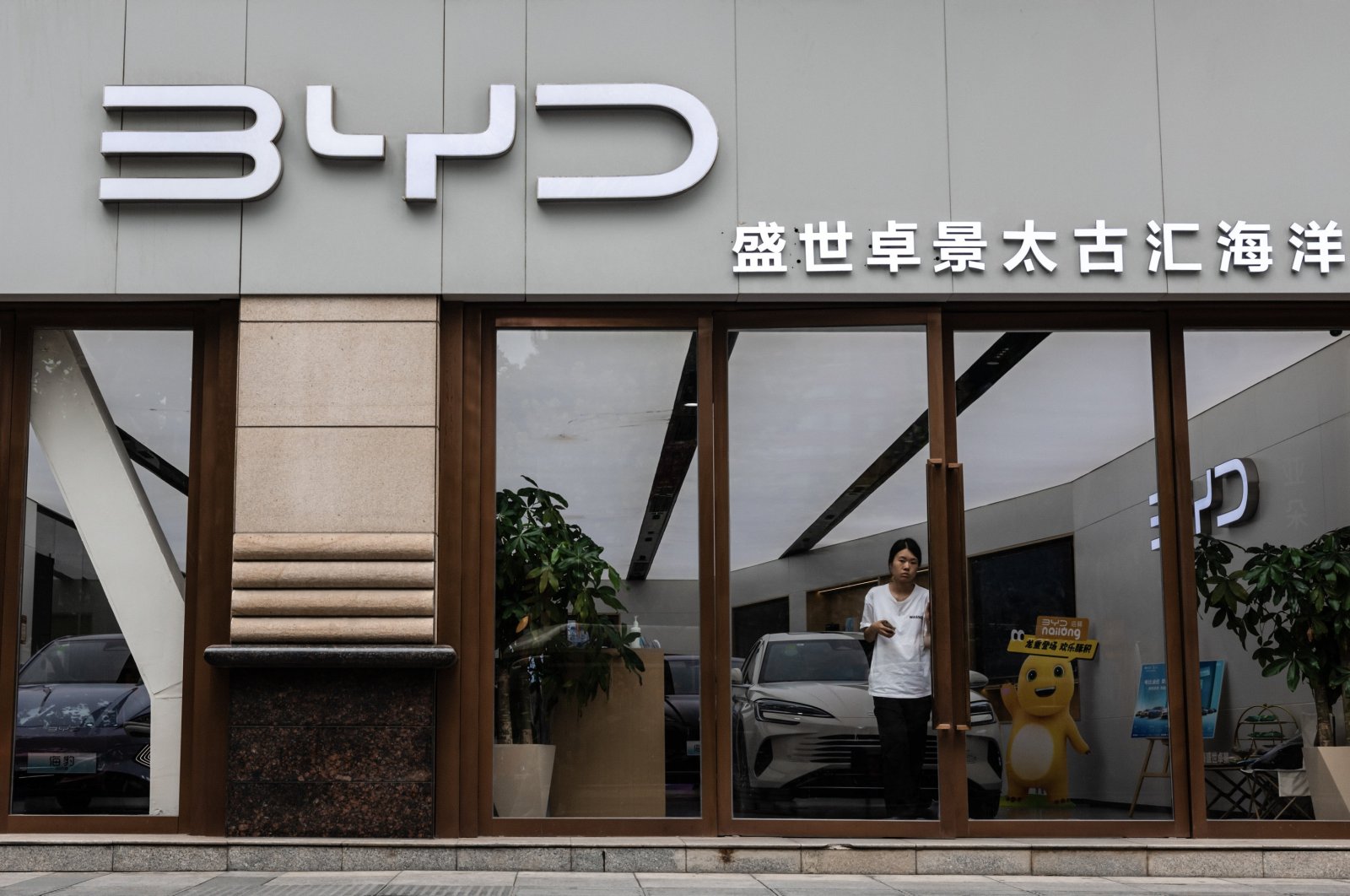 A woman exits a store of the electric vehicle manufacturer BYD, Shanghai, China, Aug. 21, 2024. (EPA Photo)