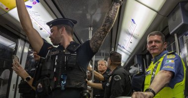 A French police officer (L), two U.S. Los Angeles officers (C) and an Irish police officer (R) keep watch during a patrol mission in the metro, during the Paris Olympic Games, Paris, France, Aug. 8, 2024. (EPA Photo)