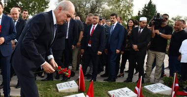 Parliament Speaker Numan Kurtulmuş leaves red carnations for the soldiers killed in the Battle of Dumlupınar, at a cemetery in central Kütahya province, Türkiye, Aug. 25, 2024. (AA Photo)