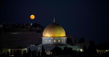 A Super Blue Moon rises behind the Dome of the Rock in the al-Aqsa Mosque compound in occupied East Jerusalem, Aug. 19, 2024. (AFP Photo)