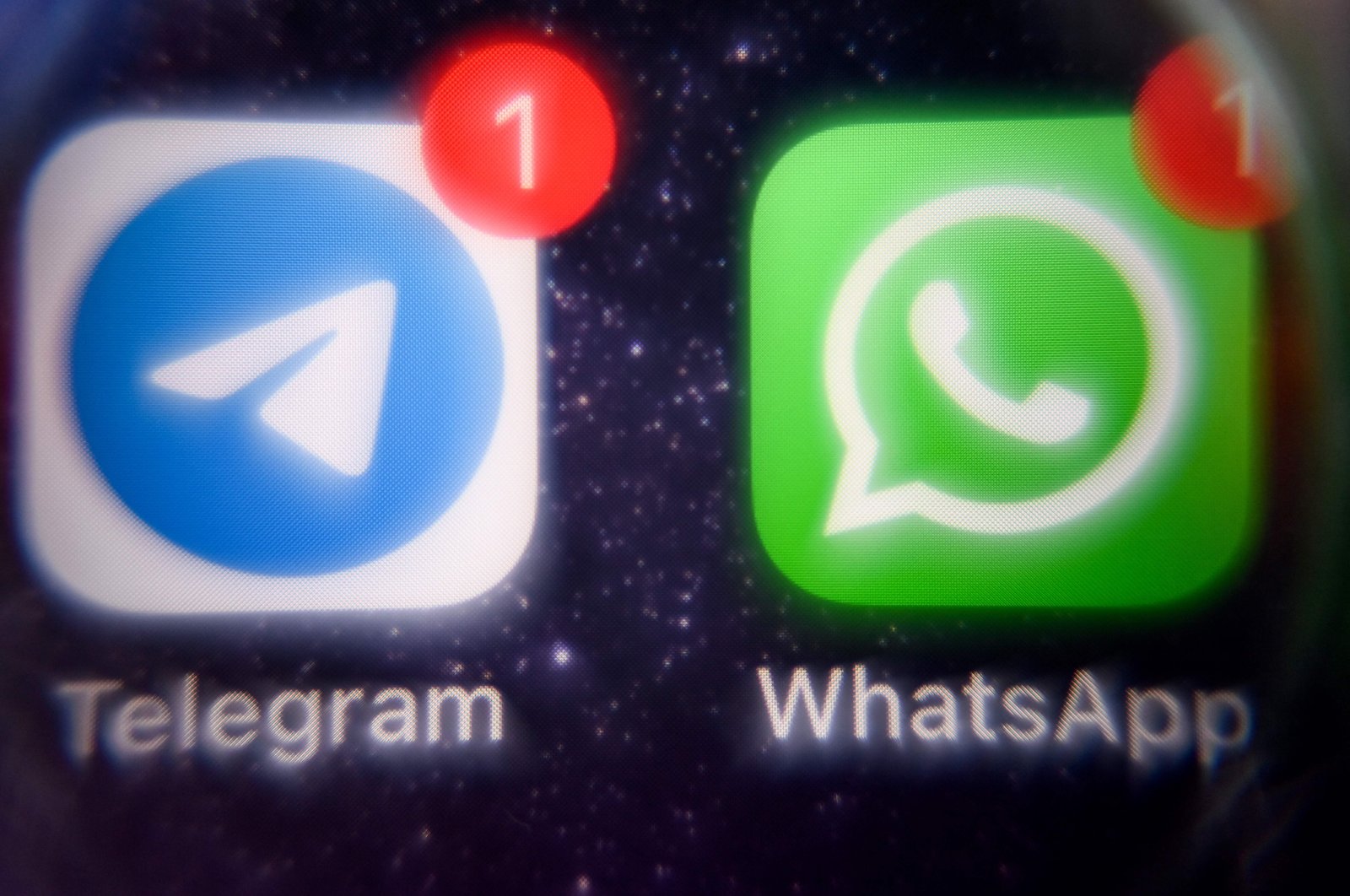 This picture shows the mobile messaging and call service Telegram logo and U.S. instant messaging software Whatsapp logo on a smartphone screen, Moscow, Russia, March 23, 2022. (AFP Photo)