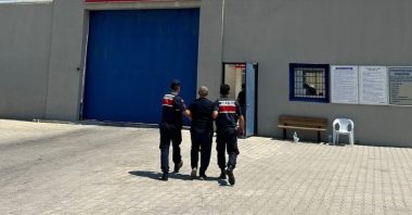 Gendarmerie officers escort a wanted FETÖ convict in southwestern Afyonkarahisar province, Türkiye, Aug. 9, 2024. (IHA Photo)