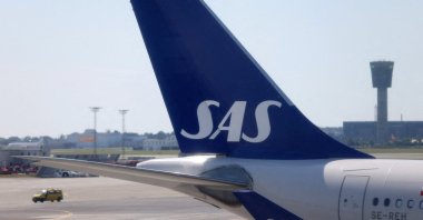 The tail fin of a parked Scandinavian Airlines (SAS) airplane is seen on the tarmac at Copenhagen Airport Kastrup, Copenhagen, Denmark, July 3, 2022. (Reuters Photo)