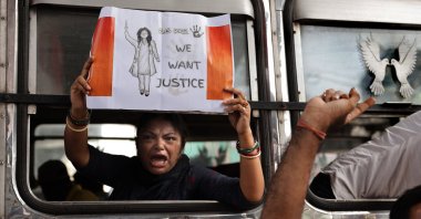 A woman carries a placard as police officers detain Bharatiya Janata Party (BJP) activists during a 12-hour general strike over the rape-murder of a doctor at RG Kar Medical College, in Kolkata, India, Aug. 28, 2024. (EPA Photo)
