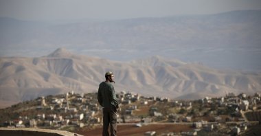 Jewish settler Refael Morris stands at an observation point overlooking the West Bank village of Duma, an unauthorized Jewish settler outpost. The "Hilltop Youth", is the ultra-religious settlers whose resentment of the secular Israeli state rivals their hostility toward Arabs. West Bank, Palestine, Jan. 5, 2016. (Reuters Photo)