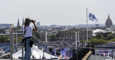 Vanesa Pena of the Spanish Civil Guard (Guardia Civil) uses binoculars as she keeps watch from a roof at Place de la Concorde, Paris, France, July 31, 2024. (EPA Photo)