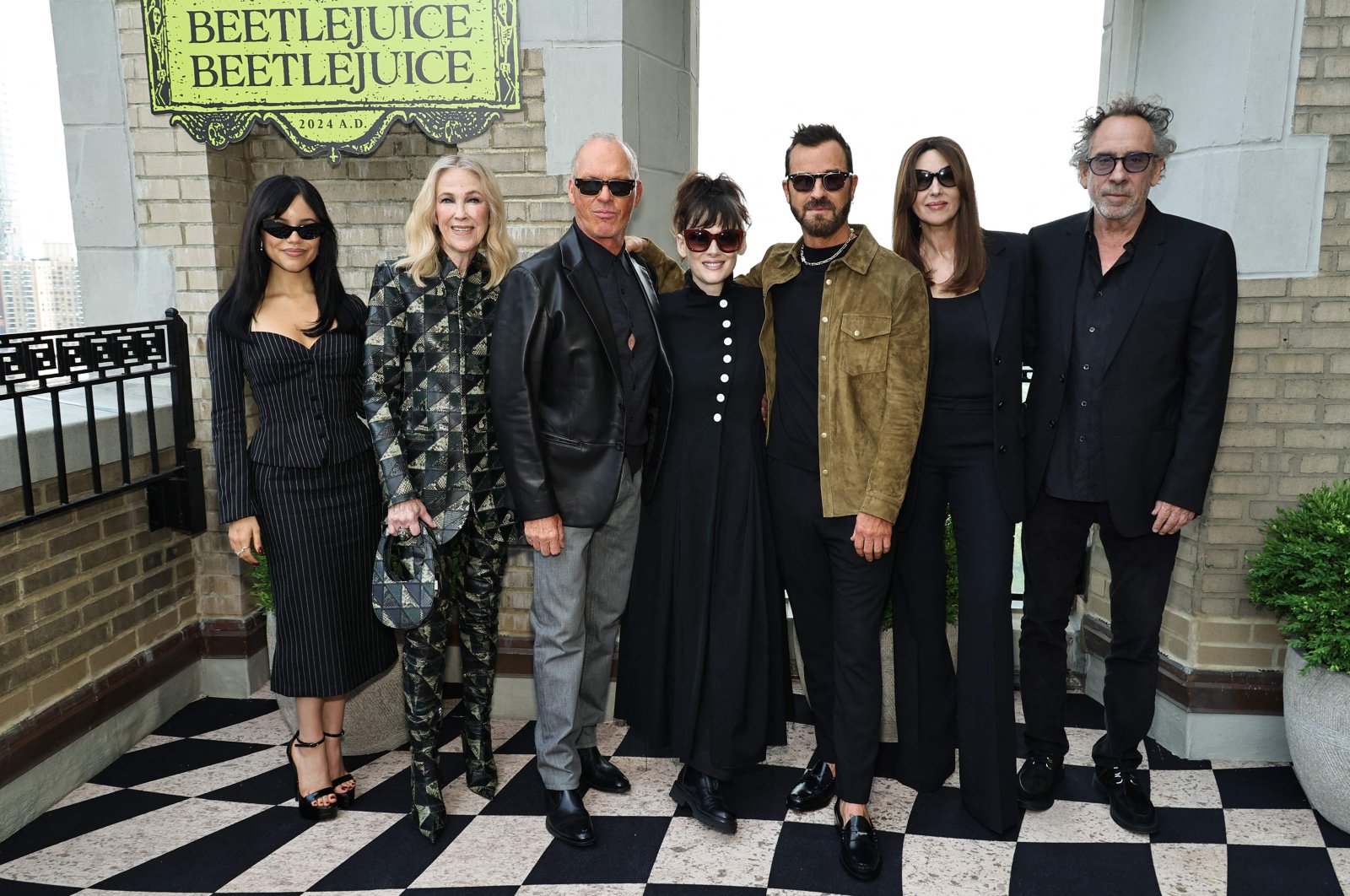 (L-R) Jenna Ortega, Catherine O&#039;Hara, Michael Keaton, Winona Ryder, Justin Theroux, Monica Bellucci and Tim Burton attend the &quot;Beetlejuice Beetlejuice&quot; New York photo call at JW Marriott Essex House, New York City, New York, U.S., Aug. 17, 2024. (AFP Photo)