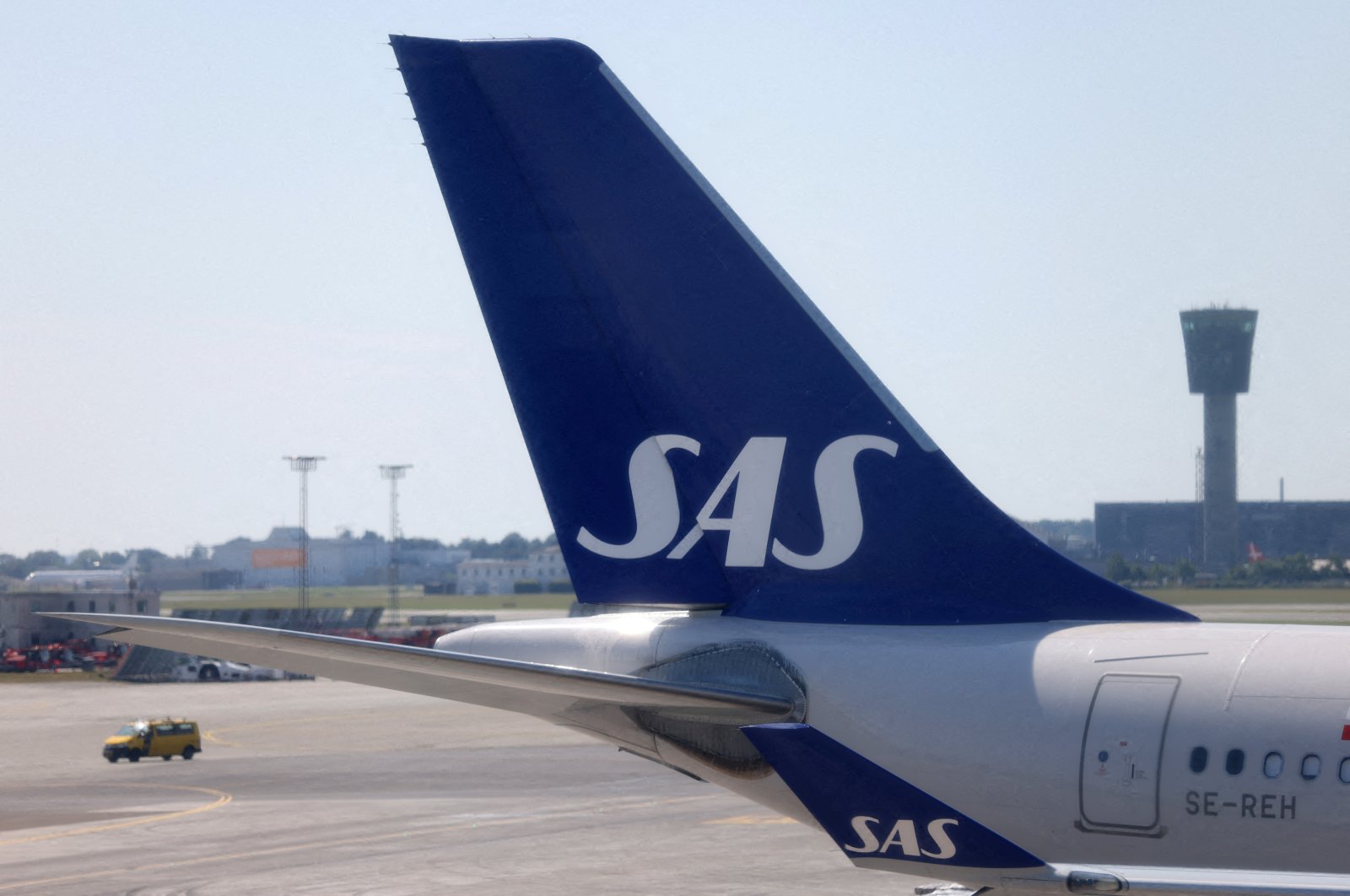 The tail fin of a parked Scandinavian Airlines (SAS) airplane is seen on the tarmac at Copenhagen Airport Kastrup, Copenhagen, Denmark, July 3, 2022. (Reuters Photo)