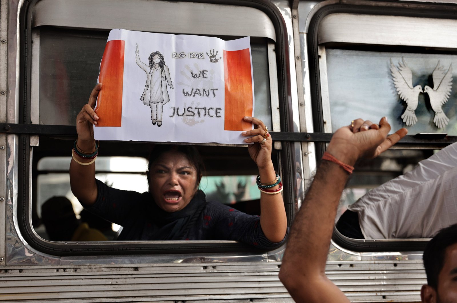 A woman carries a placard as police officers detain Bharatiya Janata Party (BJP) activists during a 12-hour general strike over the rape-murder of a doctor at RG Kar Medical College, in Kolkata, India, Aug. 28, 2024. (EPA Photo)