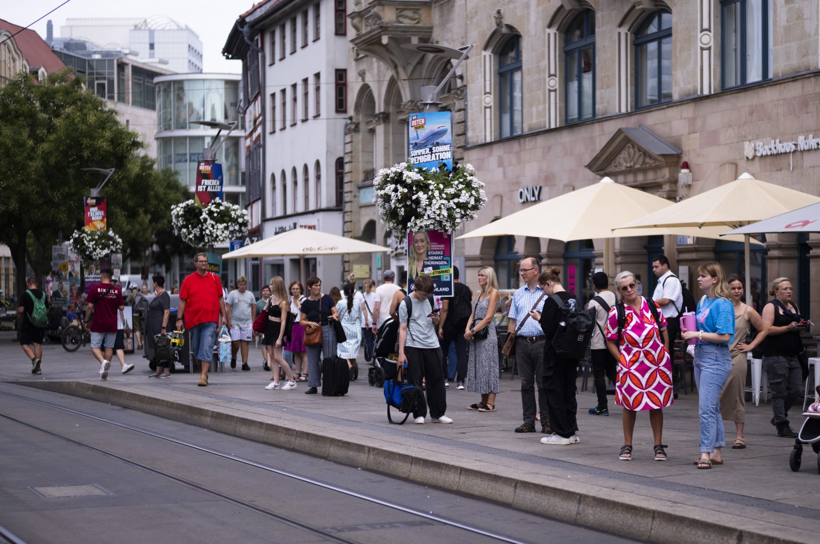 Electoral posters of the far-right Alternative for Germany party (AfD) using the slogan &quot;Summer, Sun, Remigration&quot; and depicting a plane dubbed &quot;Deportation Airline&quot; are displayed at a public transport station in the capital of German federal state Thuringia, in Erfurt, Germany, Aug. 14, 2024. (AP Photo)