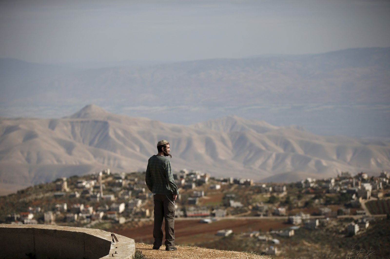 Jewish settler Refael Morris stands at an observation point overlooking the West Bank village of Duma, an unauthorized Jewish settler outpost. The "Hilltop Youth", is the ultra-religious settlers whose resentment of the secular Israeli state rivals their hostility toward Arabs. West Bank, Palestine, Jan. 5, 2016. (Reuters Photo)