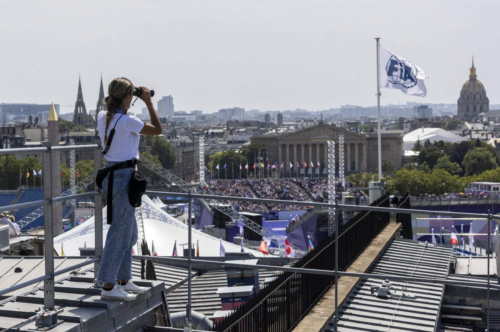 Vanesa Pena of the Spanish Civil Guard (Guardia Civil) uses binoculars as she keeps watch from a roof at Place de la Concorde, Paris, France, July 31, 2024. (EPA Photo)