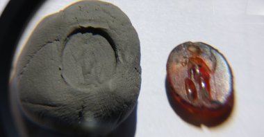 1,700-year-old ringstone with the depiction of Athena belonged to a prominent person in the city and was used as a seal, Çanakkale, Türkiye, Aug. 29, 2024. (IHA Photo)
