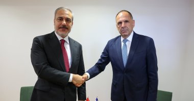 Foreign Minister Hakan Fidan (L) shakes hands with his Greek counterpart George Gerapetritis on the sidelines of an EU meeting in Brussels, Belgium, Aug. 29, 2024. (AA Photo)