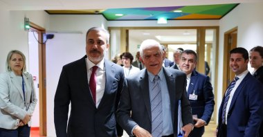 Foreign Minister Hakan Fidan and EU foreign policy chief Josep Borrell smile as they walk during the summit in Brussels, Aug. 29, 2024. (AA Photo)