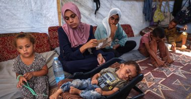 Palestinian boy Abdel Rahman Abu al-Jedian who contracted polio a month ago sleeps surrounded by family members in their displacement tent in Deir al-Balah in the central Gaza Strip, Aug. 27, 2024. (AFP Photo)