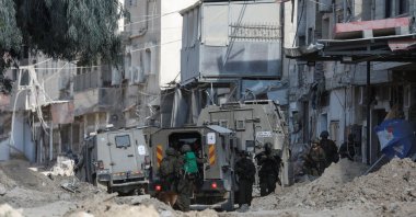 Israeli soldiers stand near a military vehicle during an Israeli raid in Nour Shams camp in Tulkarm, in the Israeli-occupied West Bank, Aug. 29, 2024. (Reuters Photo)