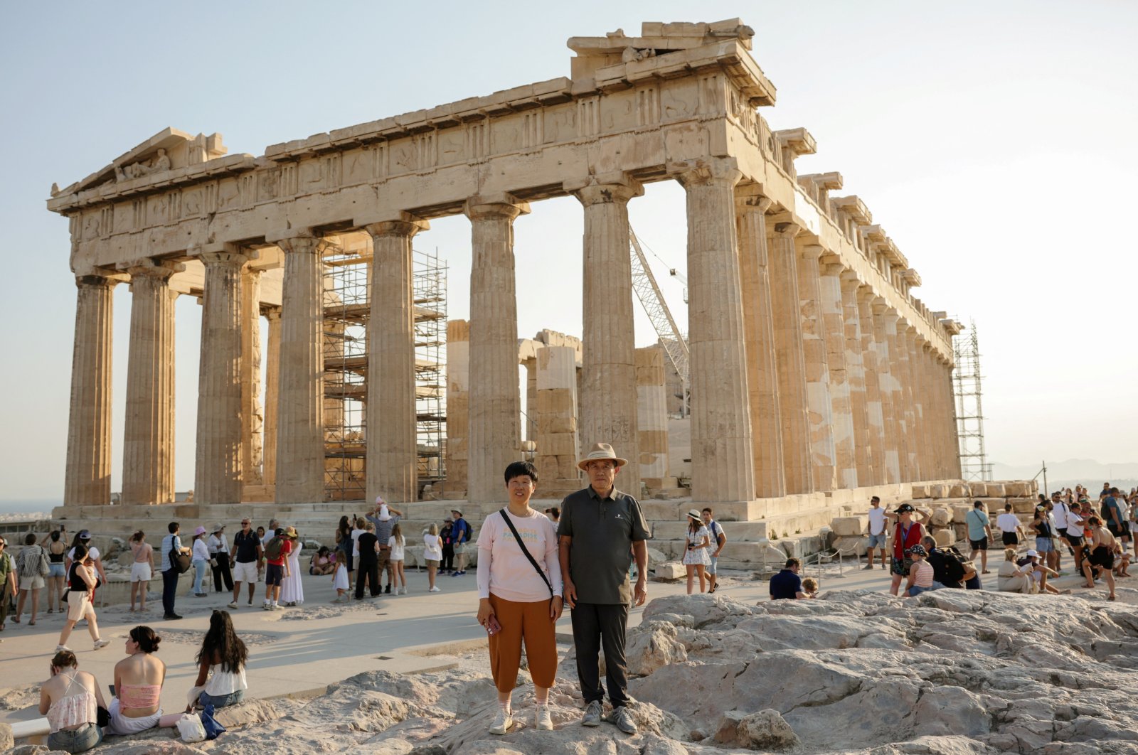 Tourists pose for a photo in front of the Parthenon temple atop the Acropolis hill, Athens, Greece, Aug. 6, 2024. (Reuters Photo)