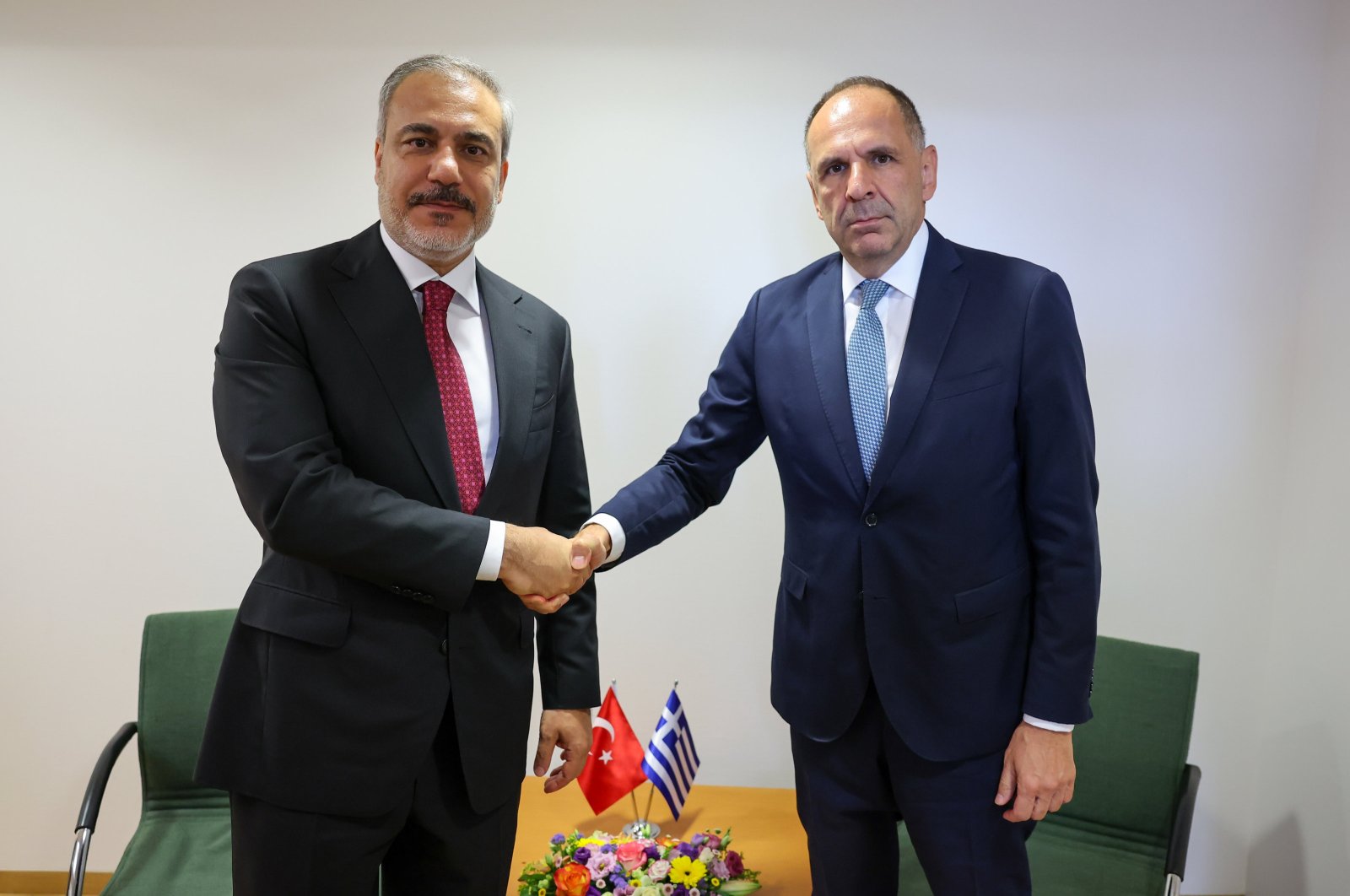 Foreign Minister Hakan Fidan (L) shakes hands with his Greek counterpart George Gerapetritis on the sidelines of an EU meeting in Brussels, Belgium, Aug. 29, 2024. (AA Photo)