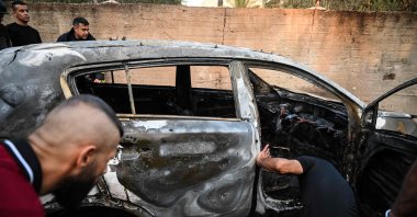 People check a burnt car in the small town of Zababdeh following an Israeli army raid, southeast of Jenin in the occupied West Bank, Palestine, Aug. 30, 2024. (AFP Photo)